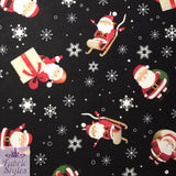 FS074 Christmas Print, Santa, Snowflakes, Sledge, Presents Spun Polyester Knit Stretch Fabric Black | Fabric | Christmas, fabric, jersey, polyester, Present, presents, rudolf, santa, Santa Clause, sledge, Snow, Snowflake, snowflakes, spun polyester, Spun Polyester Elastane, xmas | Fabric Styles