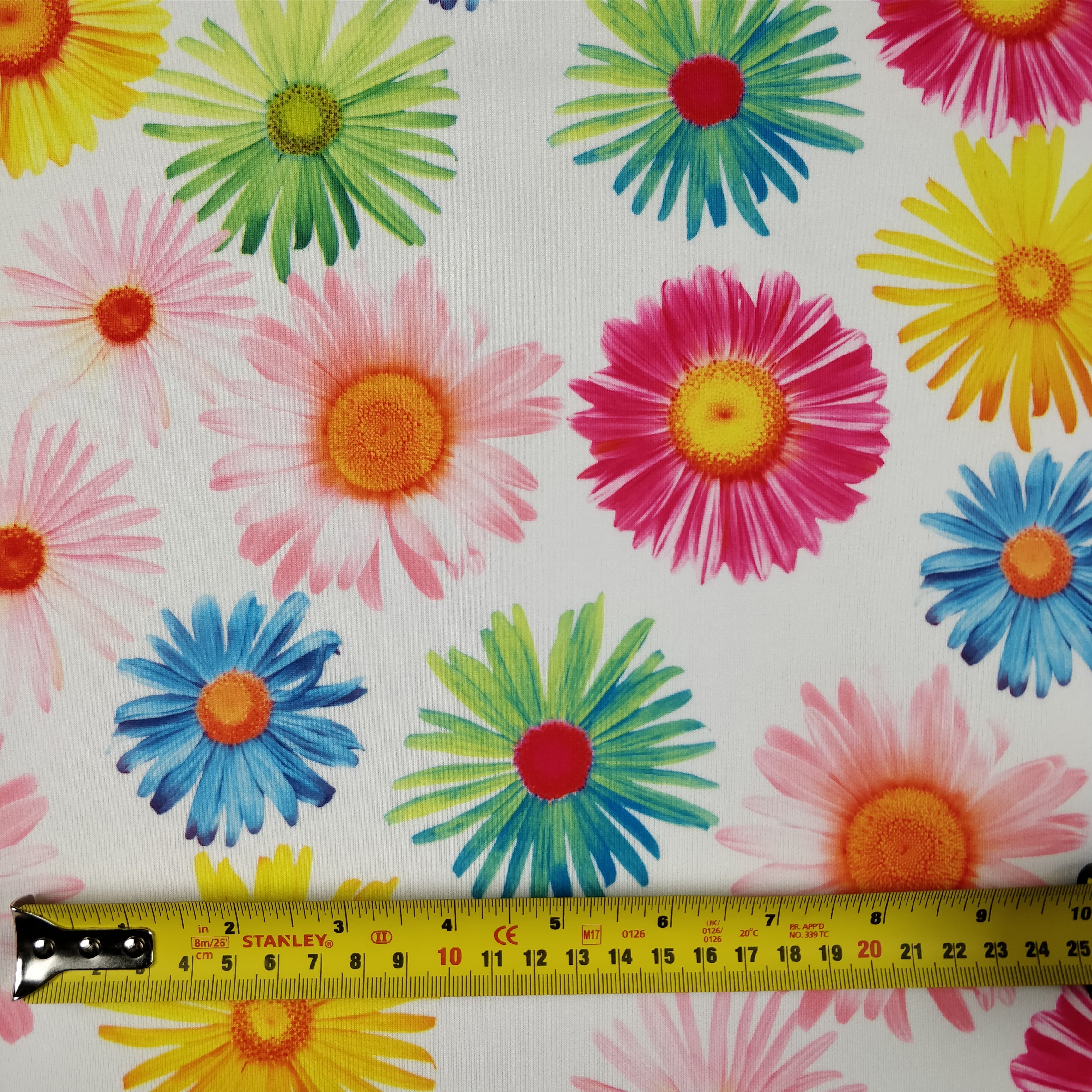 FS207_1 Multi Colour Gerbra Daisy | Fabric | Black, Blue, Daisies, Daisy, drape, Dress Fabric, Dress making, Dressmaking Fabric, Fabric, fabricstyles, fashion fabric, Floral, Flower, Green, Light Pink, making, Orange, Pink, Purple, Scuba, sewing, sunflower, White, Yellow | Fabric Styles